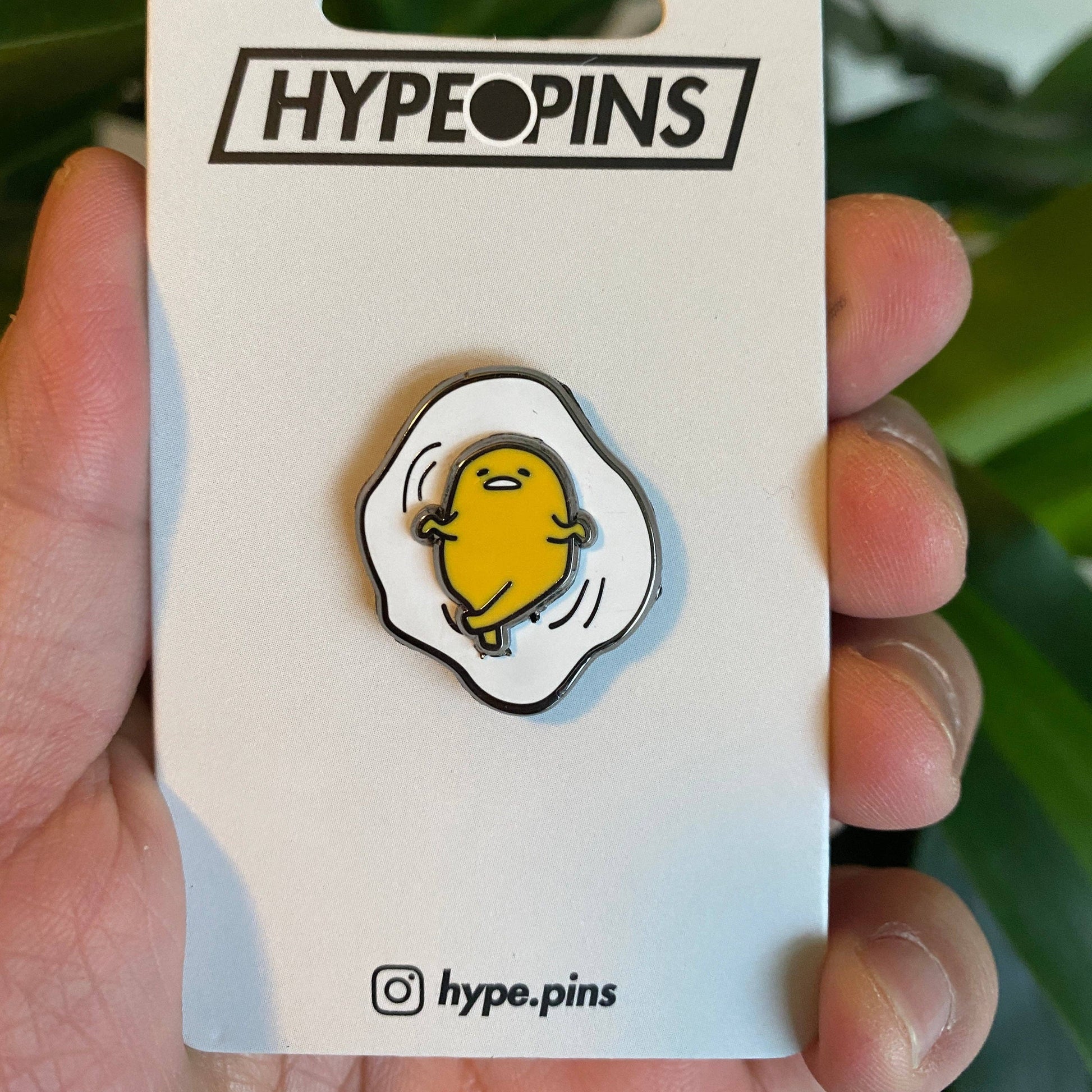 Gudetama Spinning Enamel Pin on card backing